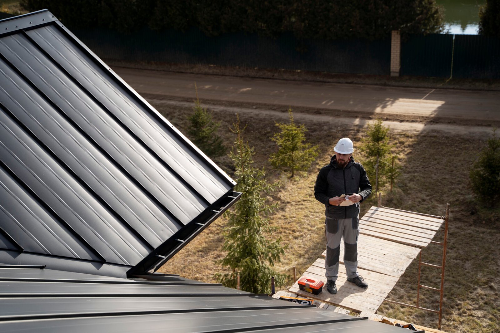 Technician cleaning gutters on a residential home in Long Island